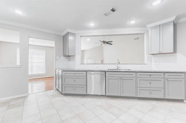 a spacious bathroom with a granite countertop sink and a mirror