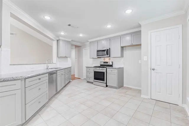 a view of empty room with fireplace and a ceiling fan