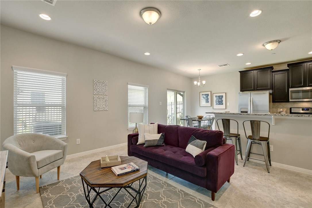 1311 Catalan Road Austin, TX 78748 - Photo 1 of 1 a living room with furniture a window and a view of kitchen