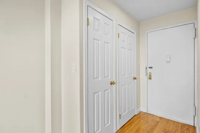 a view of a hallway with wooden floor