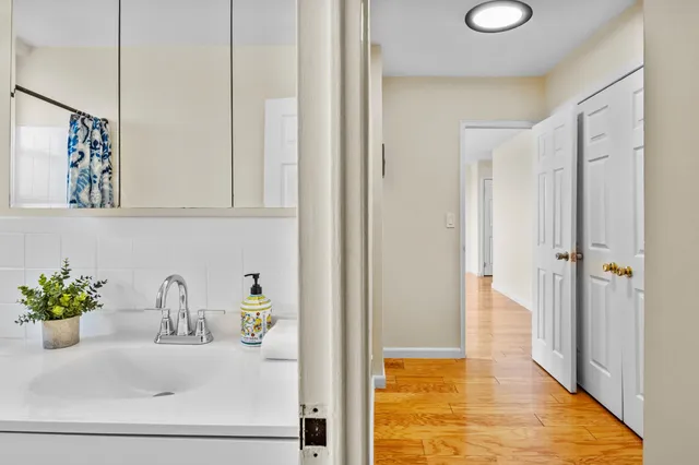 a bathroom with a sink a mirror and a shower