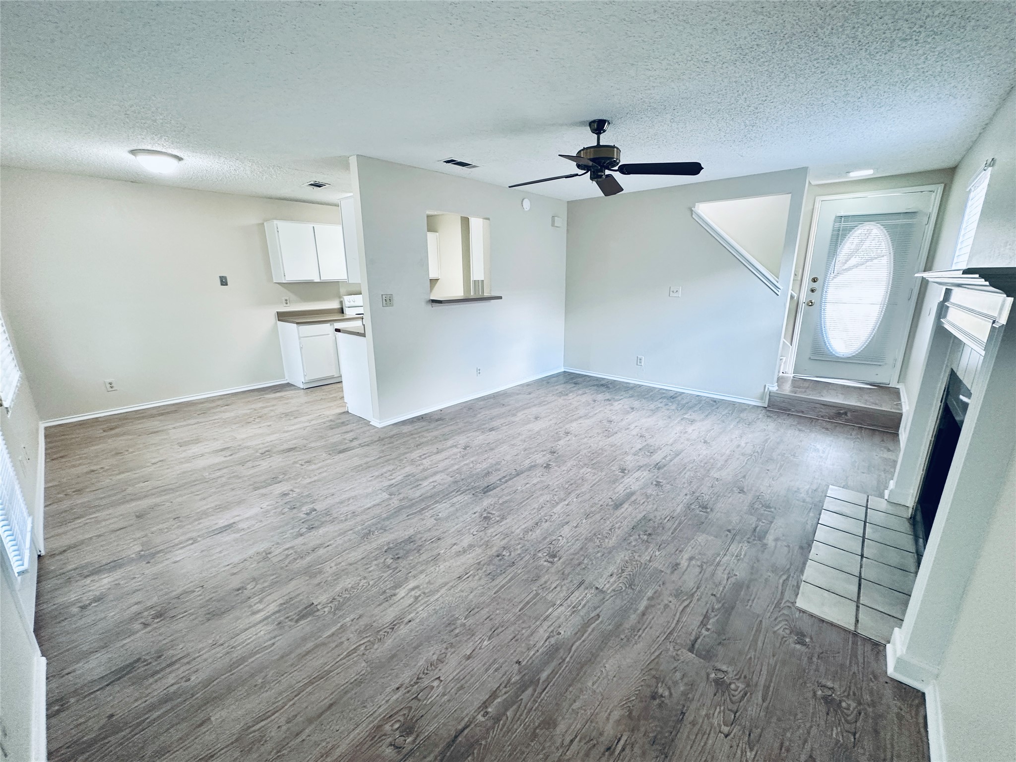 379 Fantail Loop, Unit B Austin, TX 78734 - Photo 7 of 33 An open layout connects the fireplace-warmed living room directly to the kitchen.