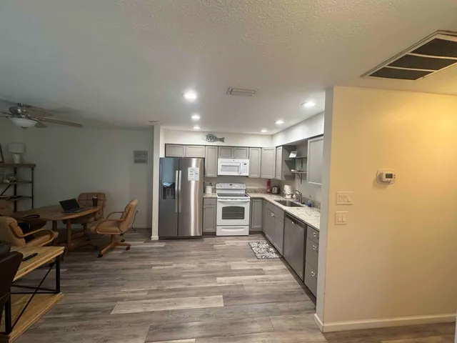 a kitchen with stainless steel appliances granite countertop a stove and a refrigerator