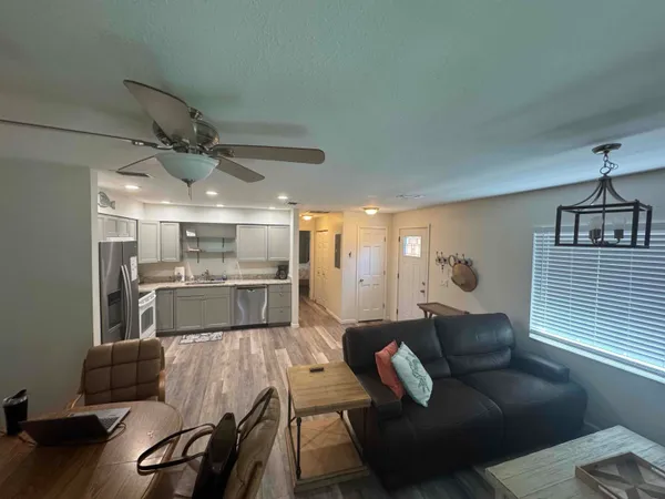 a living room with furniture and a chandelier