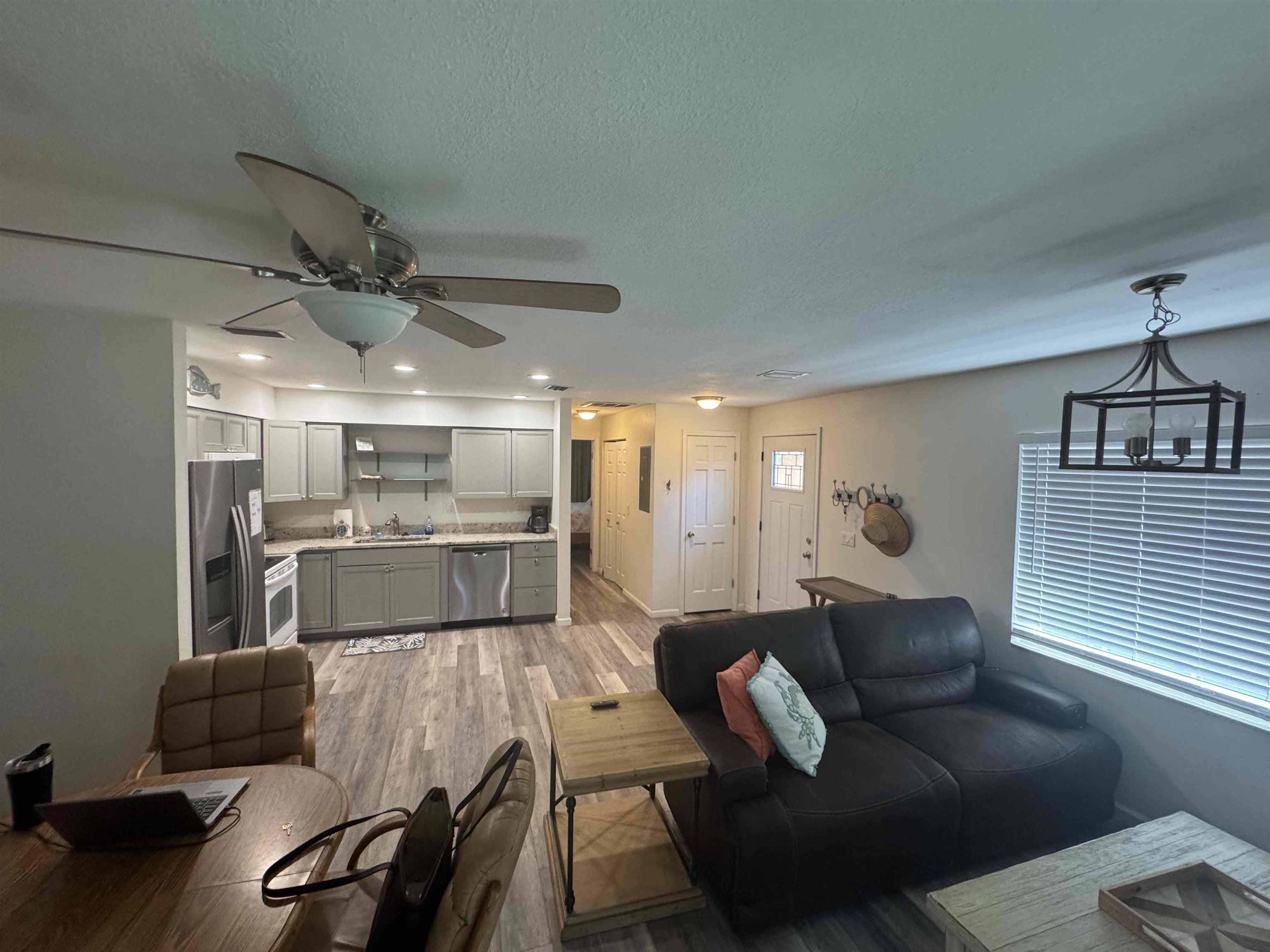 113 2nd Street, Unit A St. Augustine, FL 32080 - Photo 5 of 10 a living room with furniture and a chandelier