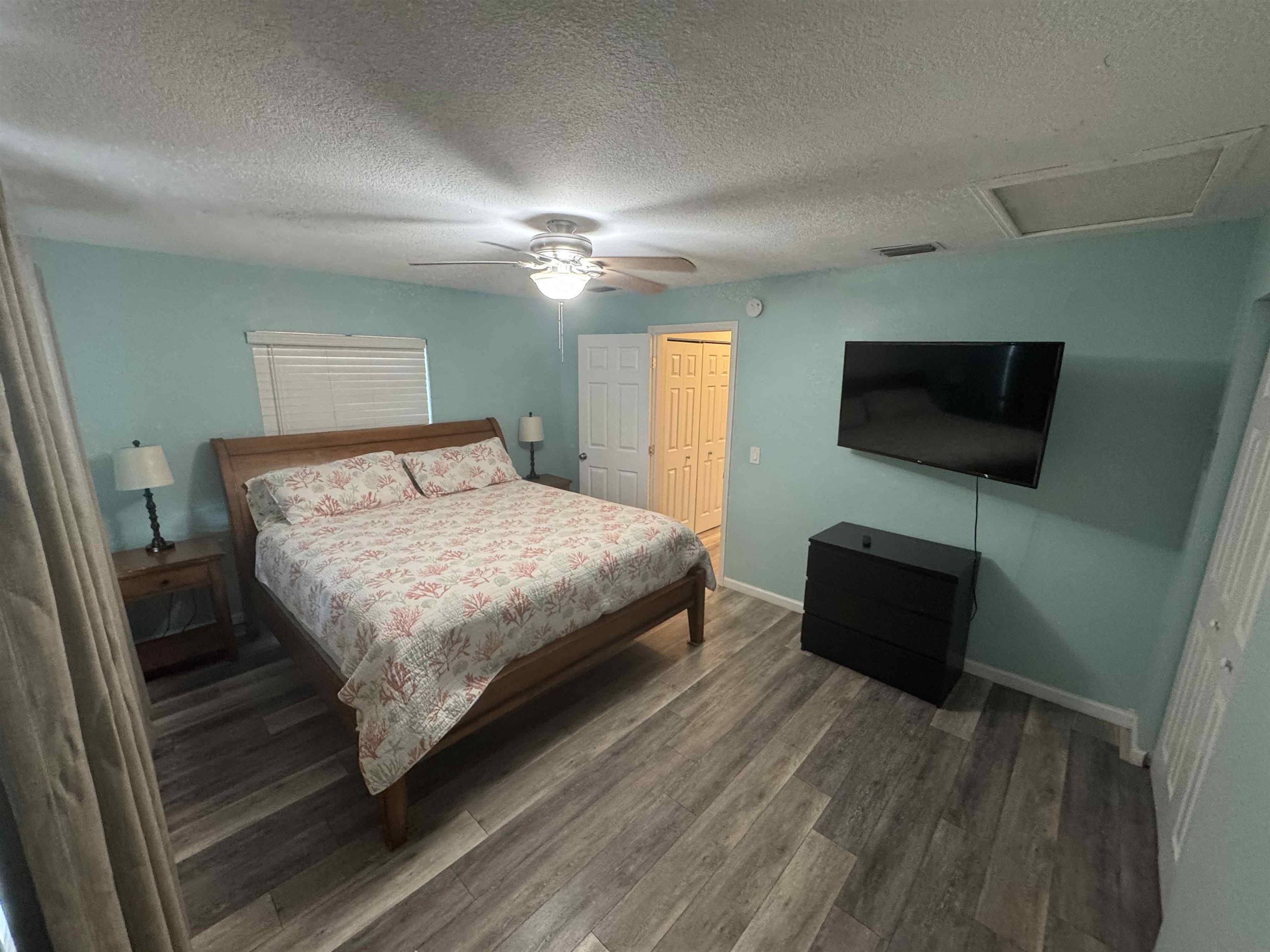113 2nd Street, Unit A St. Augustine, FL 32080 - Photo 6 of 10 a bedroom with a bed and a flat screen tv