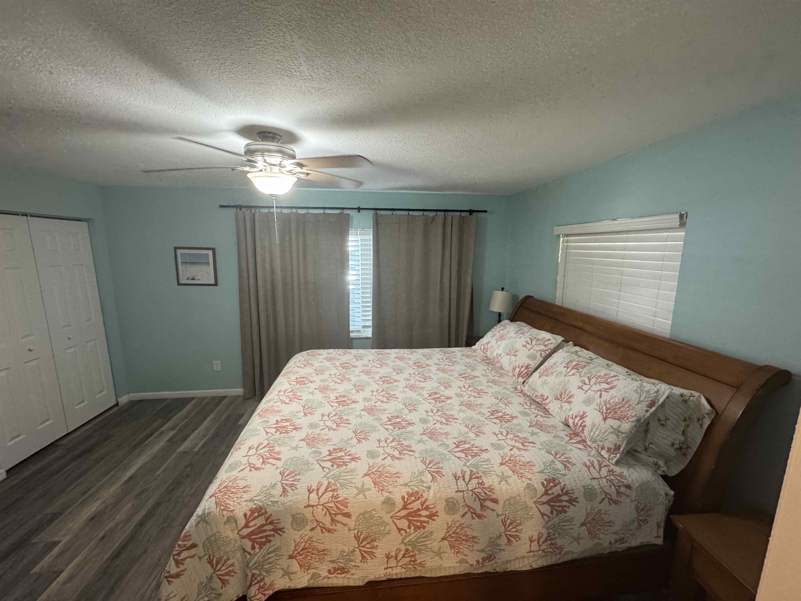 113 2nd Street, Unit A St. Augustine, FL 32080 - Photo 7 of 10 a bedroom with a bed and a chandelier