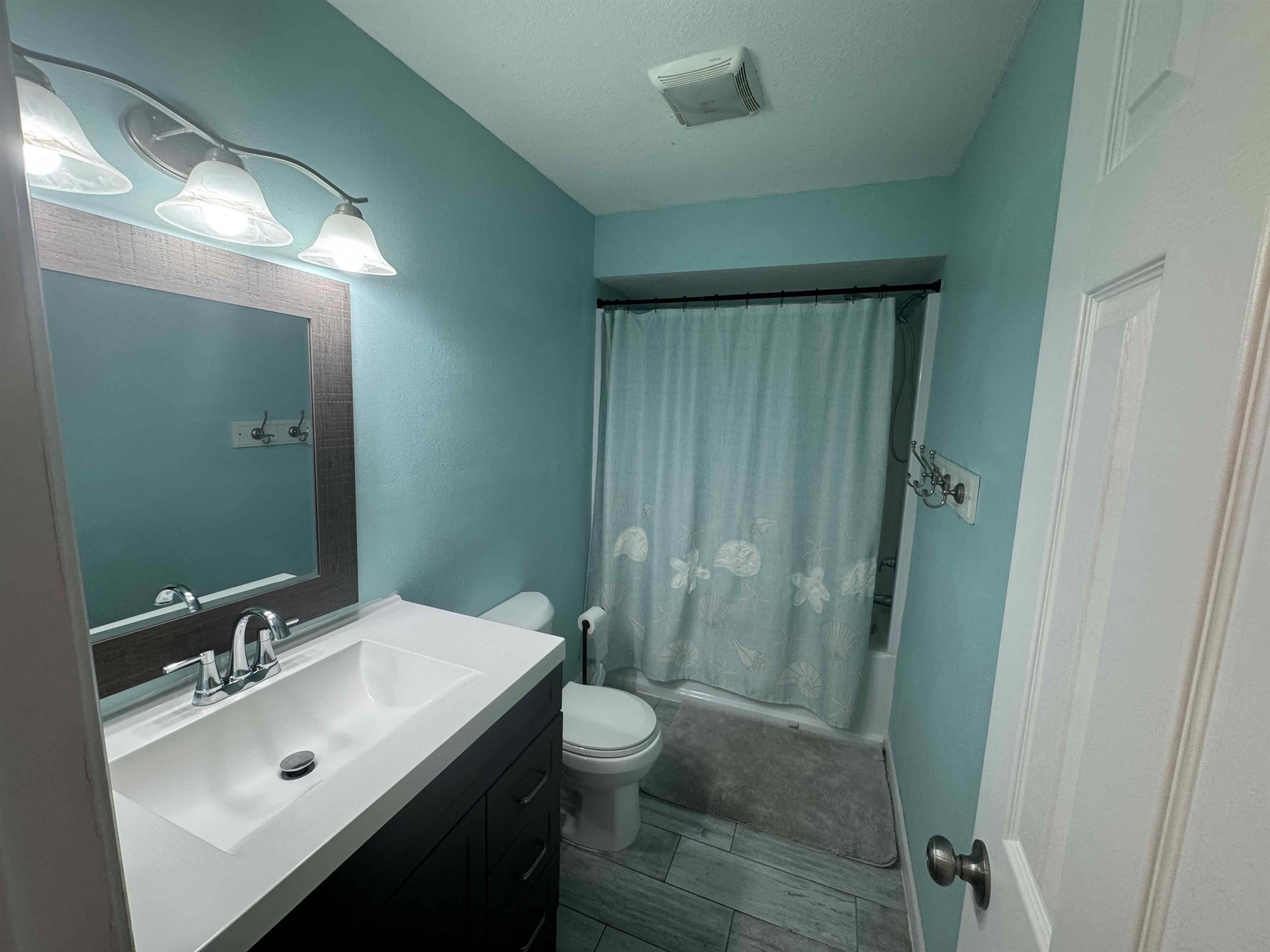 113 2nd Street, Unit A St. Augustine, FL 32080 - Photo 9 of 10 a bathroom with a sink a toilet and shower