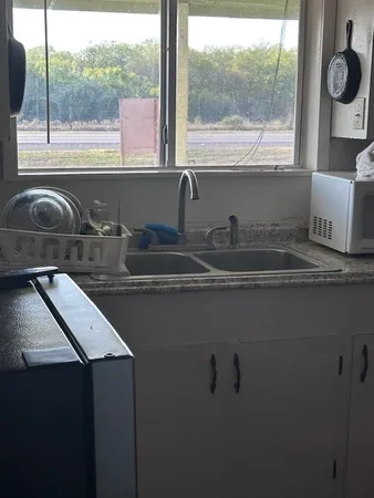 a kitchen with a sink and a window