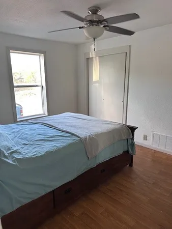 a bedroom with a bed and a window