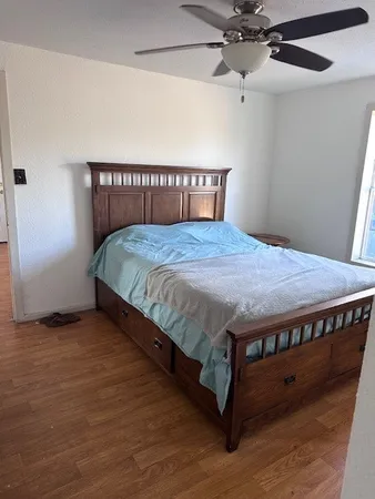 a bed sitting in a bedroom next to a window
