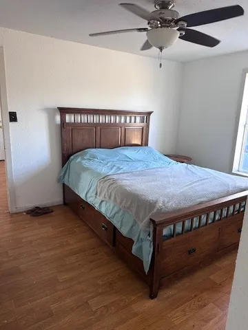 a bed sitting in a bedroom next to a window