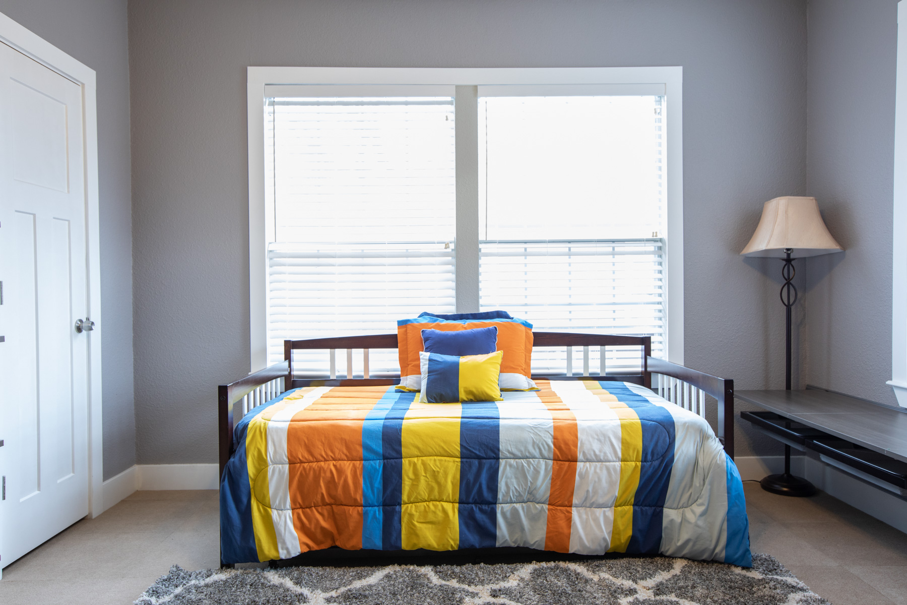 702 West N Loop Boulevard Austin, TX 78751 - Photo 4 of 23 A well-lit bedroom offering comfort and functionality, complete with carpeted floors.