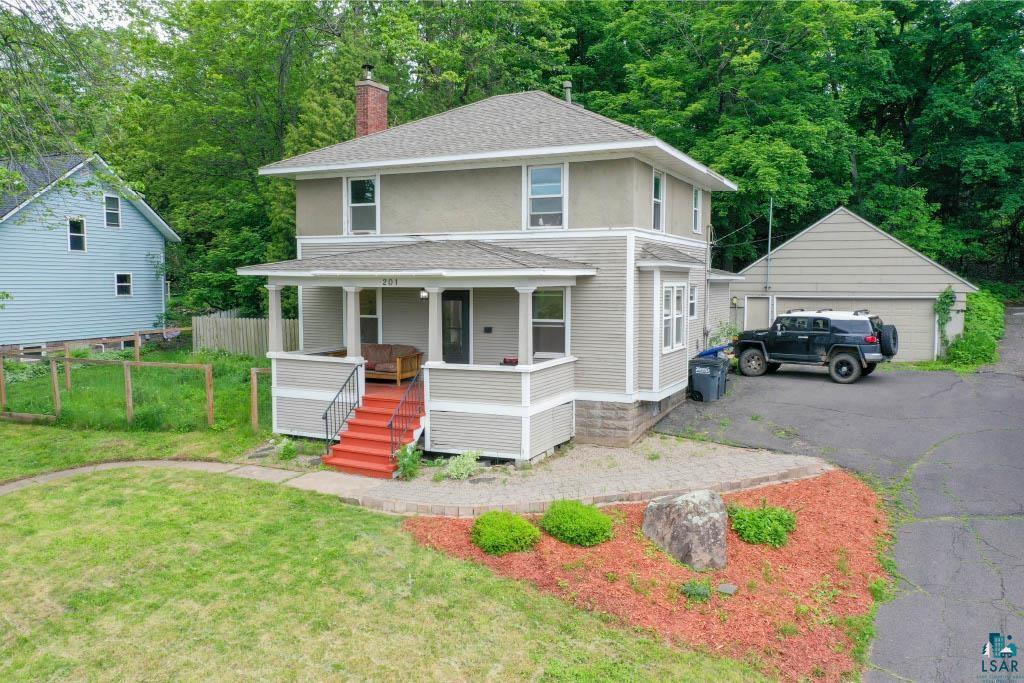 201 Snively Road Duluth, MN 55803 - Photo 1 of 21 View of front of house featuring a garage, a porch, an outdoor structure, and a front yard