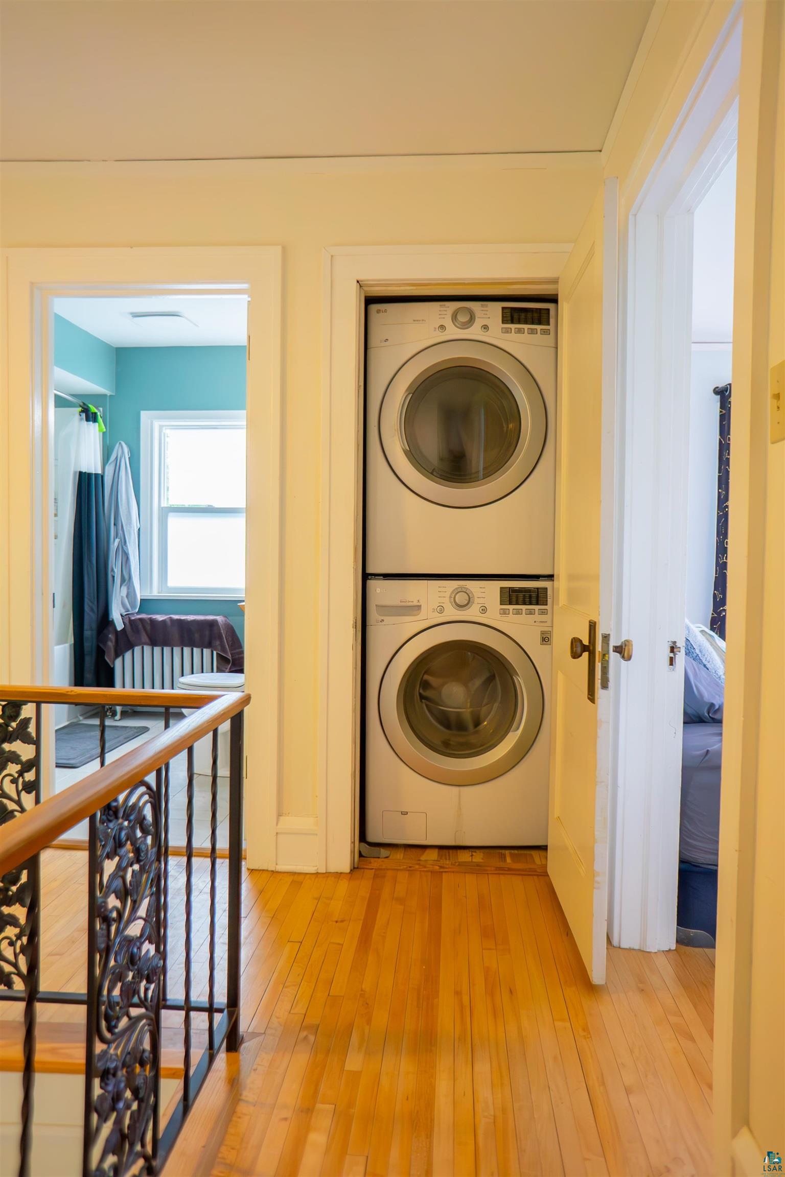 201 Snively Road Duluth, MN 55803 - Photo 13 of 21 Laundry area featuring stacked washer / dryer and light wood-type flooring