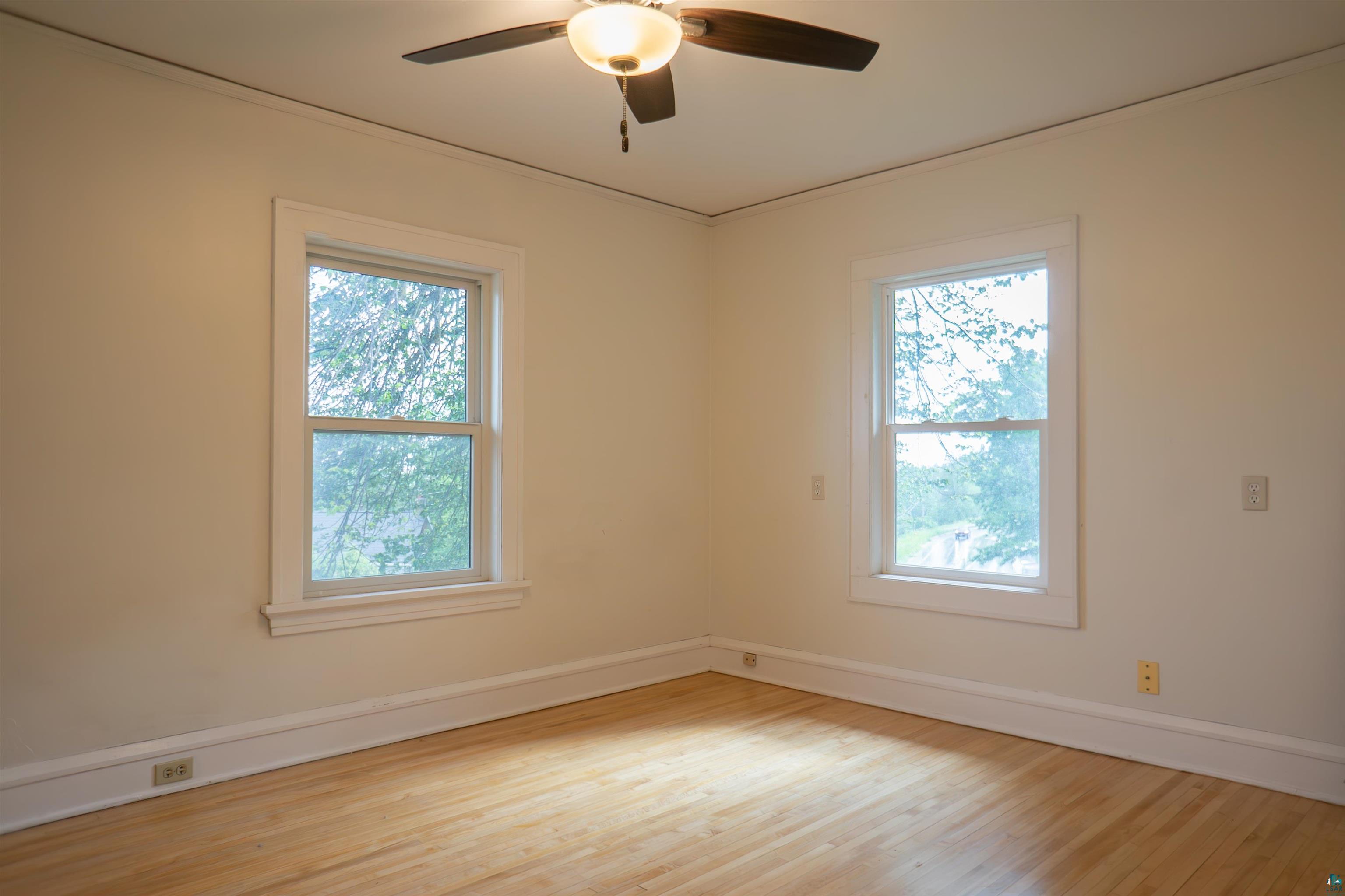 201 Snively Road Duluth, MN 55803 - Photo 15 of 21 Spare room featuring a healthy amount of sunlight, light wood-type flooring, and ceiling fan