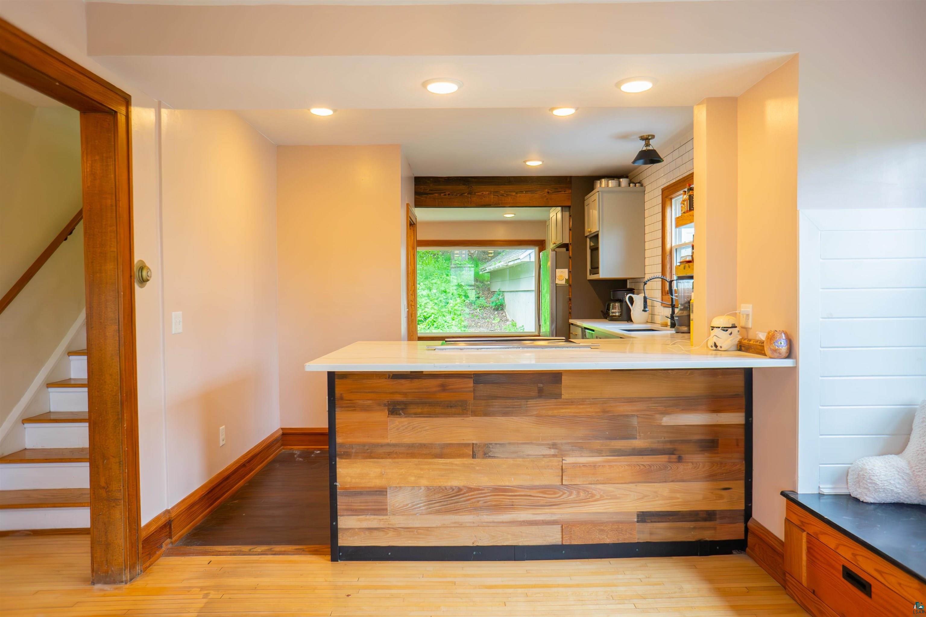 201 Snively Road Duluth, MN 55803 - Photo 7 of 21 Kitchen featuring light hardwood / wood-style floors, sink, and kitchen peninsula