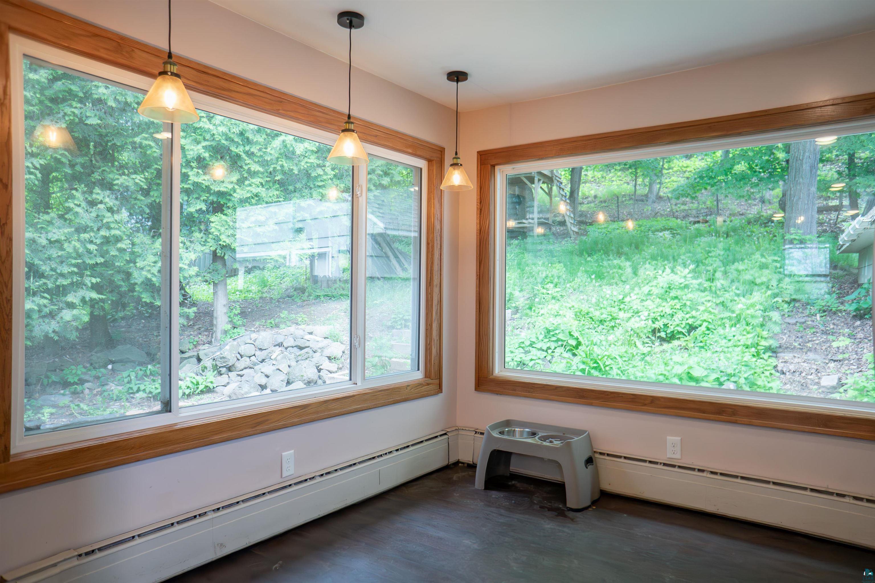 201 Snively Road Duluth, MN 55803 - Photo 10 of 21 Interior space with dark hardwood / wood-style flooring and a baseboard heating unit