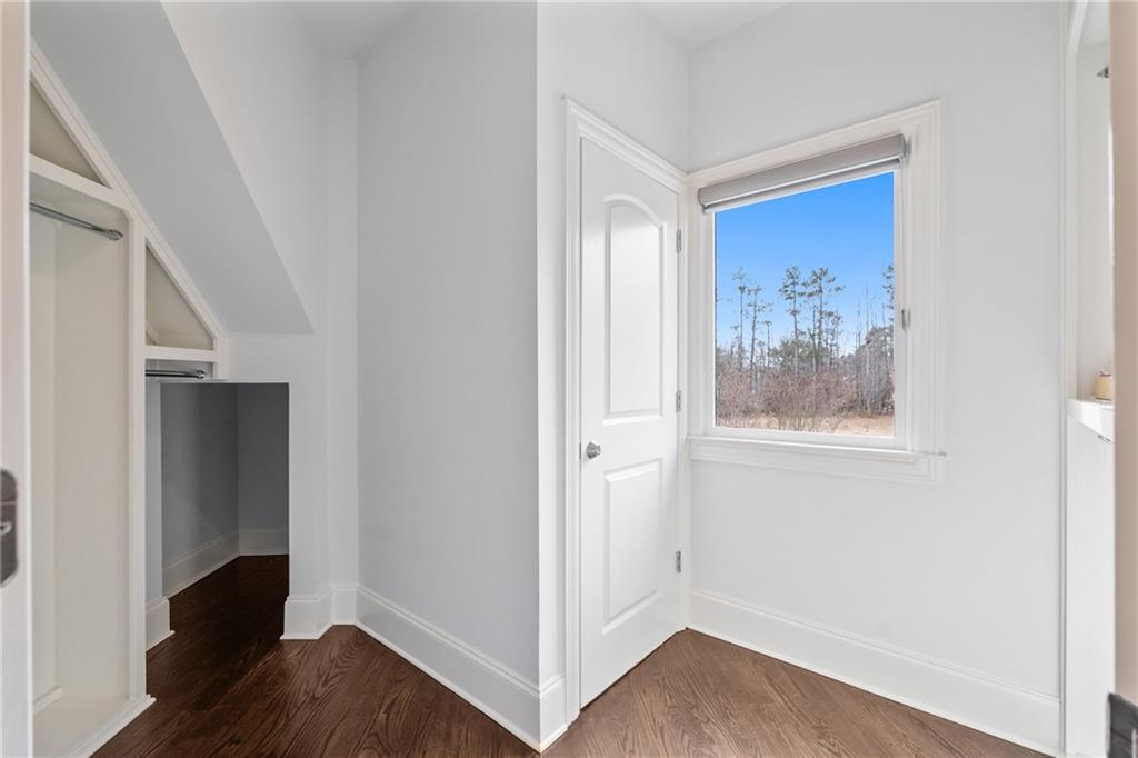 14560 Wood Road Milton, GA 30004 - Photo 41 of 74 a view of a hallway with wooden floor and closet