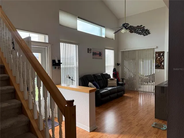 a living room with furniture wooden floor and a chandelier