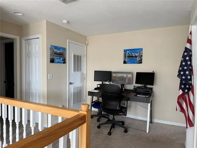 a view of a workspace with furniture