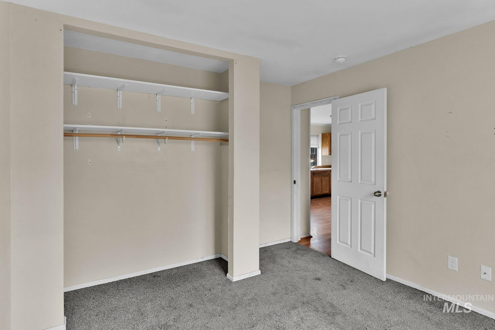 4715 West Reeves Street Coeur D'Alene, ID 83814 - Photo 15 of 24 Unfurnished bedroom featuring carpet flooring and a closet