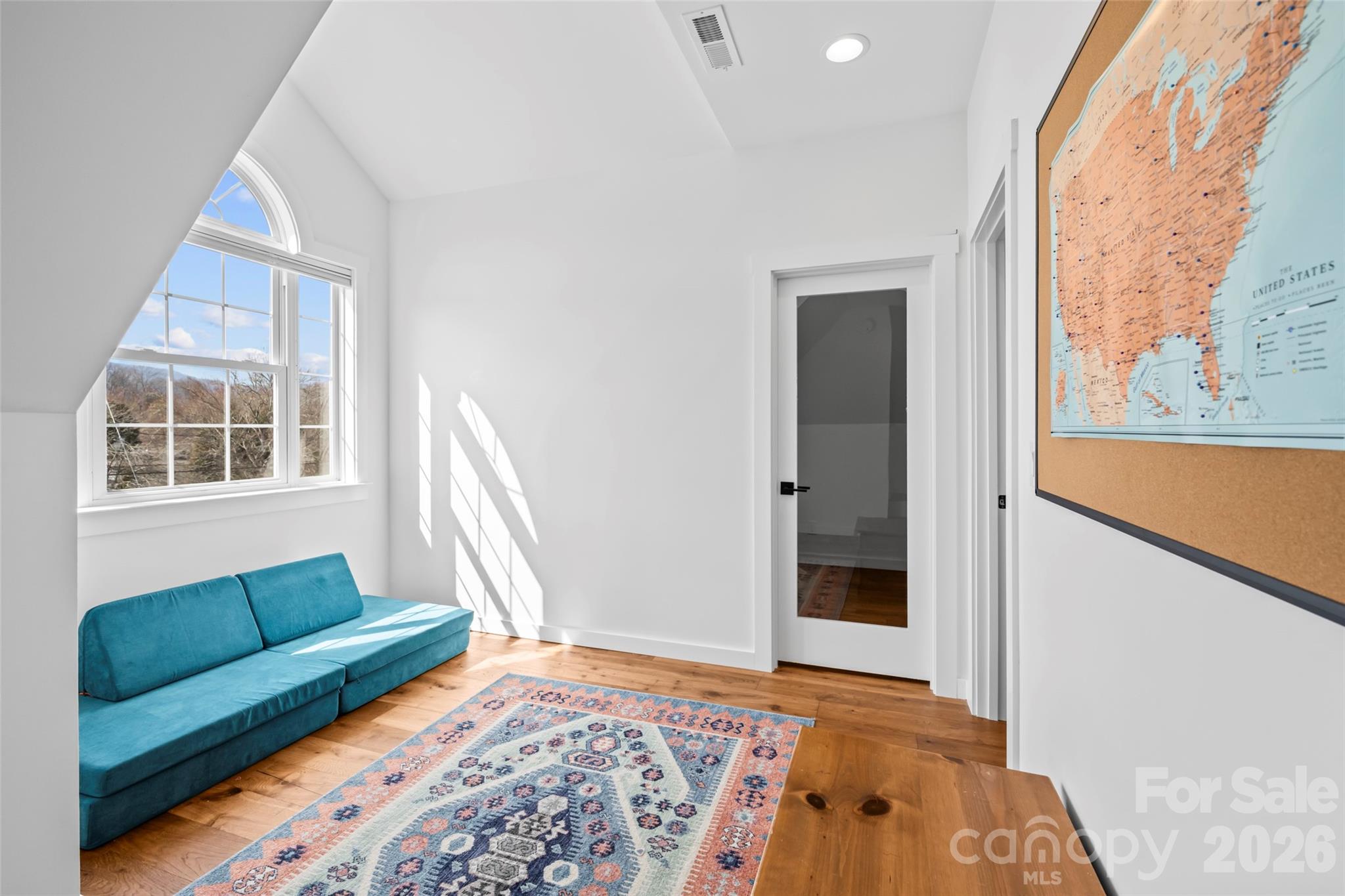 719 Neely Road Brevard, NC 28712 - Photo 16 of 33 a living room with a bed furniture and a large window