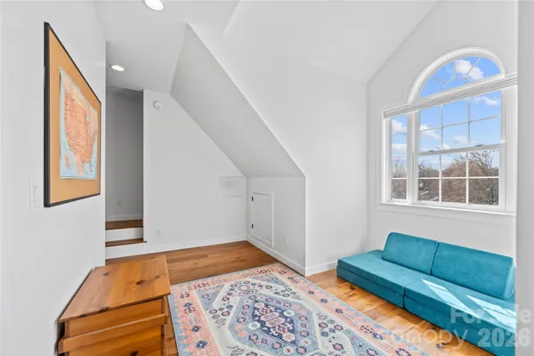 a bedroom with furniture and a window