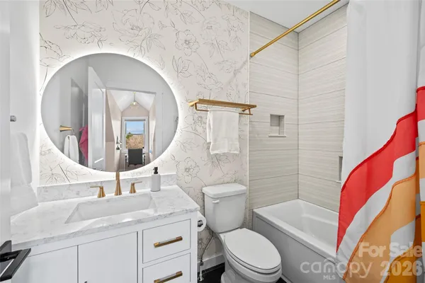 a bathroom with a sink and mirror with toilet