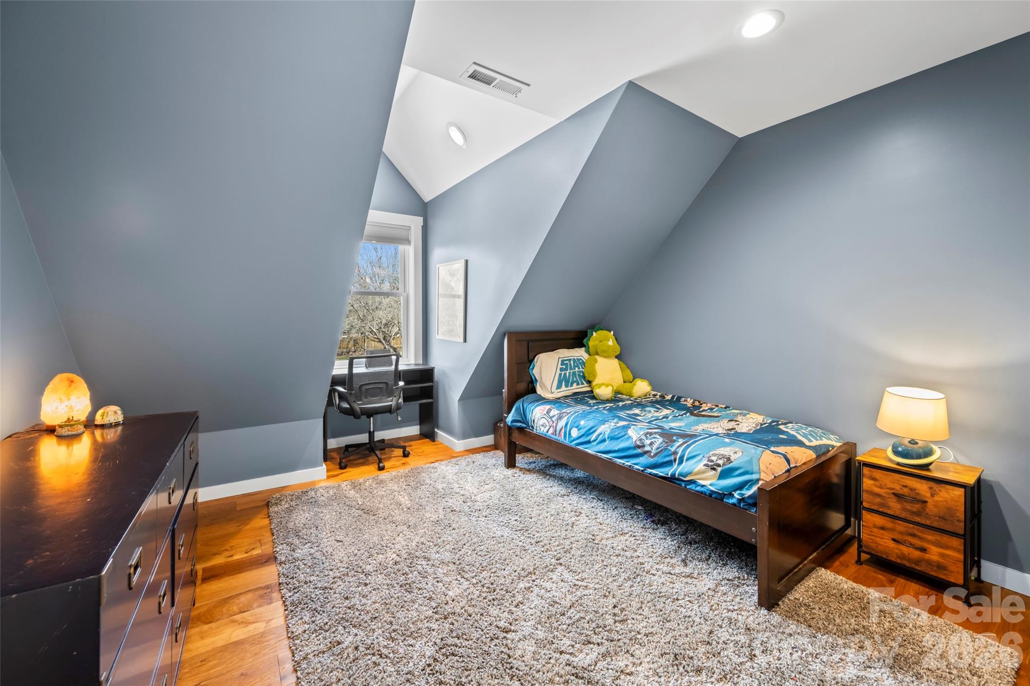 719 Neely Road Brevard, NC 28712 - Photo 21 of 33 a bedroom with furniture and a wooden floor