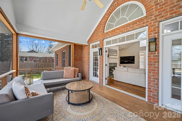 a living room with furniture and a floor to ceiling window