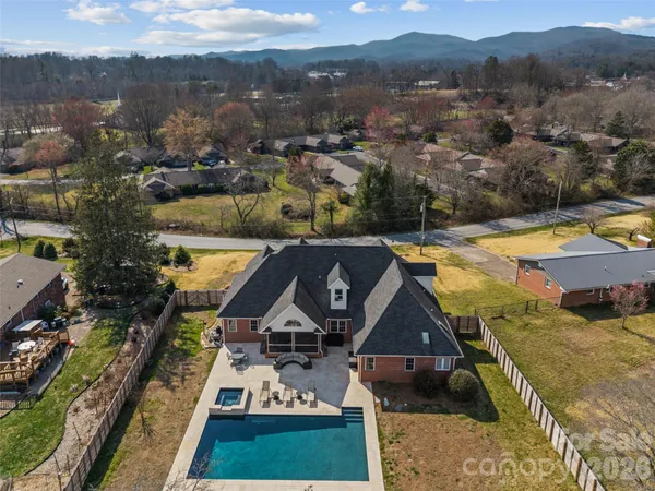 a view of a house with swimming pool and a yard