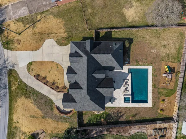an aerial view of a house with a yard