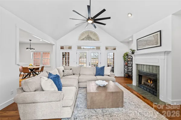 a living room with furniture a clock and a fireplace