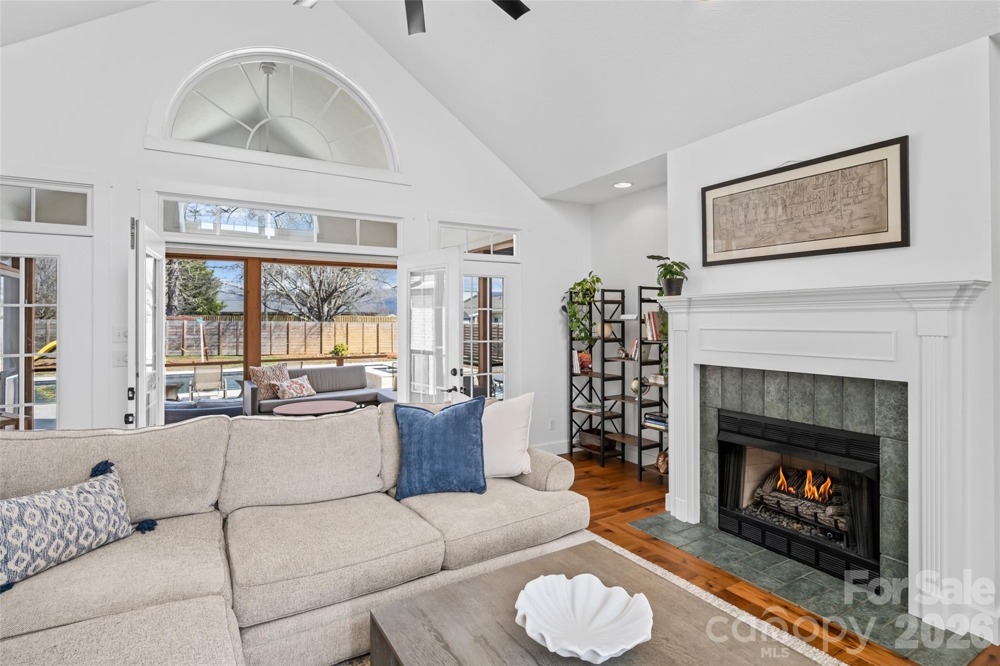 719 Neely Road Brevard, NC 28712 - Photo 5 of 33 a living room with furniture a fireplace and a large window