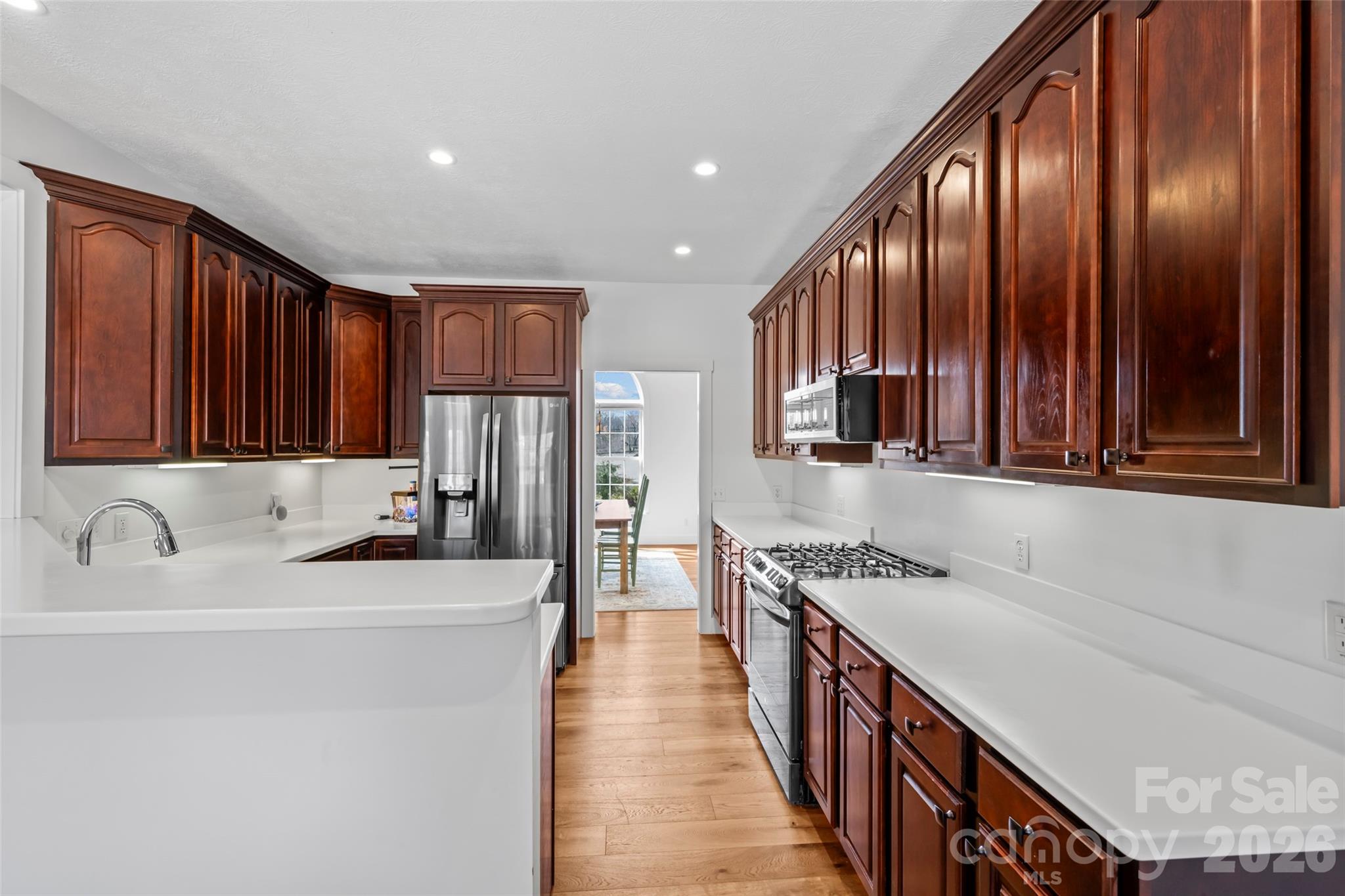 719 Neely Road Brevard, NC 28712 - Photo 8 of 33 a kitchen with stainless steel appliances granite countertop a refrigerator a stove and a sink with wooden cabinets