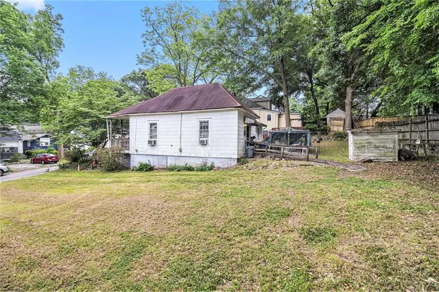 a view of a house with a yard and sitting area