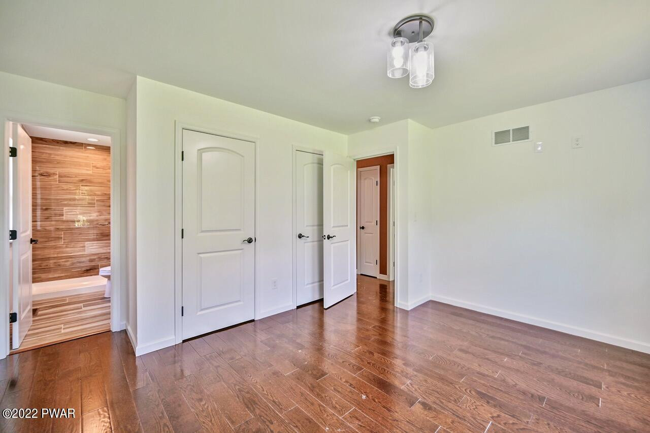 45 Rockway Road Lake Ariel, PA 18436 - Photo 50 of 65 a view of an empty room with wooden floor and a window