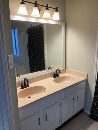 a bathroom with a double vanity sink and mirror