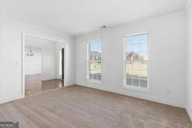 an empty room with windows and closet