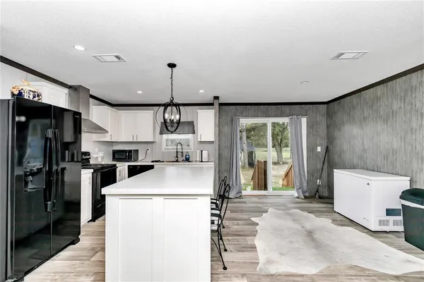 a bedroom with furniture and a flat screen tv