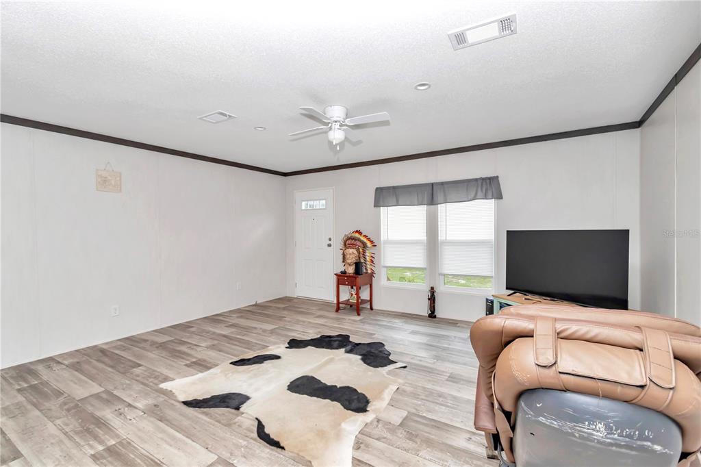 5190 Southwest 178th Terrace Dunnellon, FL 34432 - Photo 17 of 51 a bedroom with furniture and a flat screen tv