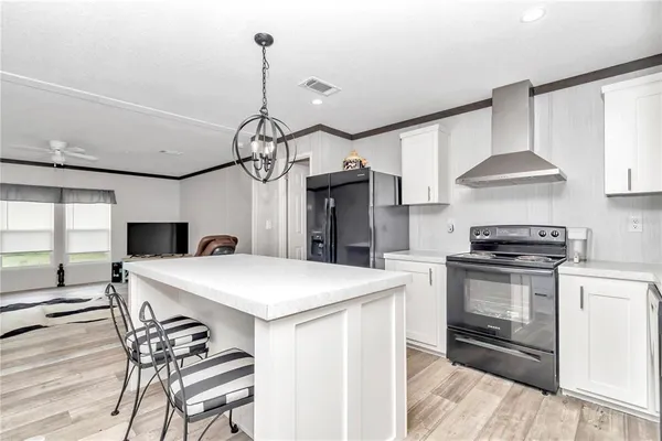 a kitchen with a sink cabinets and a stove