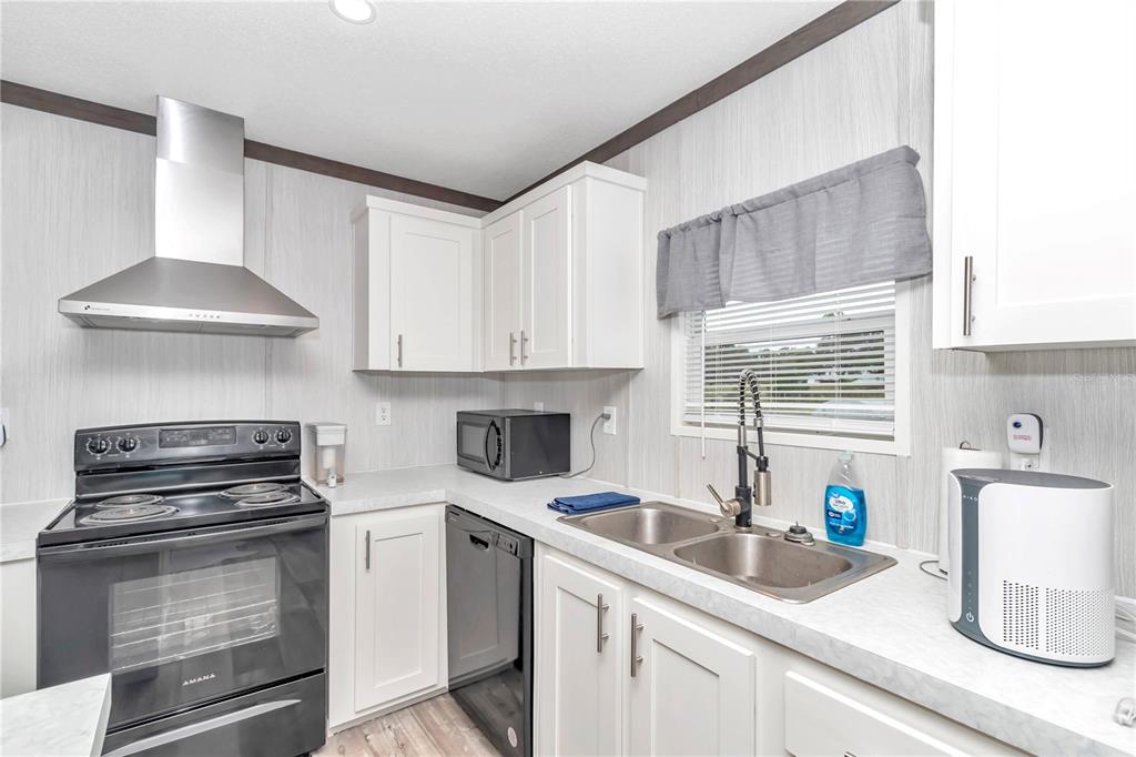 5190 Southwest 178th Terrace Dunnellon, FL 34432 - Photo 22 of 51 a kitchen with a sink cabinets and a stove