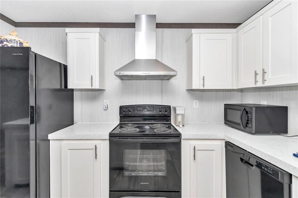 5190 Southwest 178th Terrace Dunnellon, FL 34432 - Photo 23 of 51 a kitchen with stainless steel appliances granite countertop white cabinets and a stove