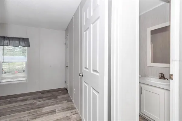 a spacious bedroom with a bed and a window