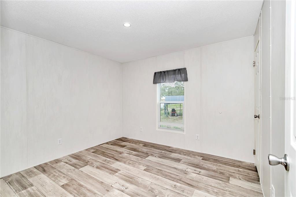 5190 Southwest 178th Terrace Dunnellon, FL 34432 - Photo 28 of 51 a view of a bedroom with a bed and a window
