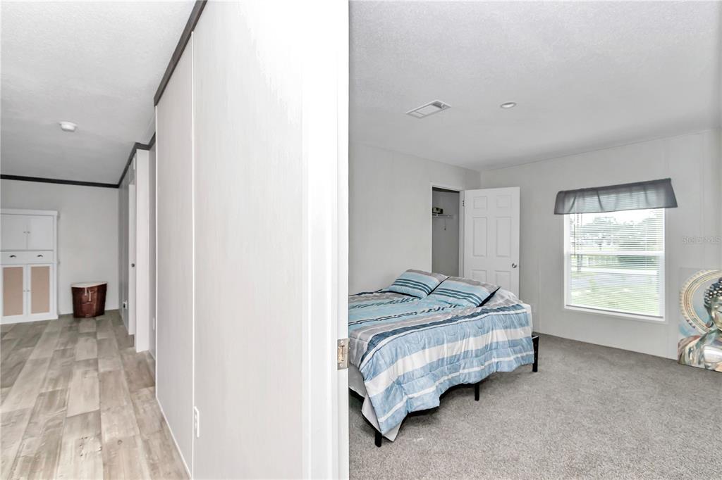 5190 Southwest 178th Terrace Dunnellon, FL 34432 - Photo 30 of 51 a spacious bedroom with a bed and a window