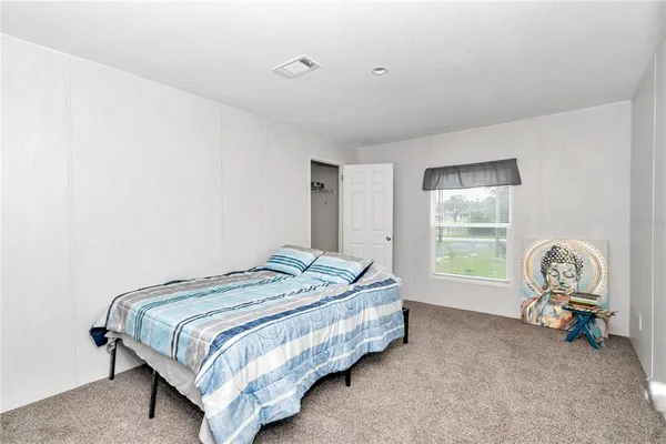 a hallway with a potted plant on a counter next to a window