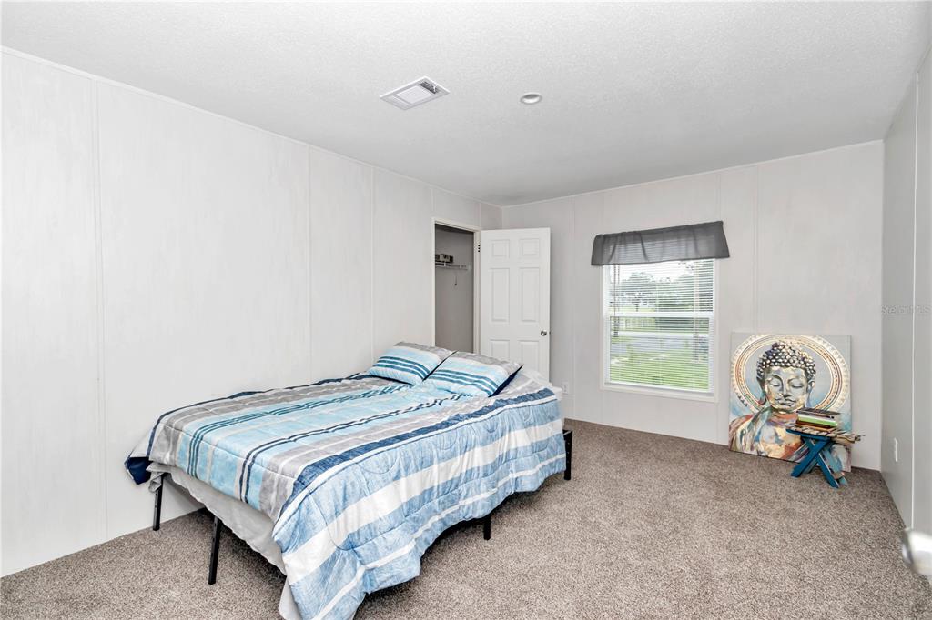 5190 Southwest 178th Terrace Dunnellon, FL 34432 - Photo 31 of 51 a bed sitting in a spacious bedroom next to a window